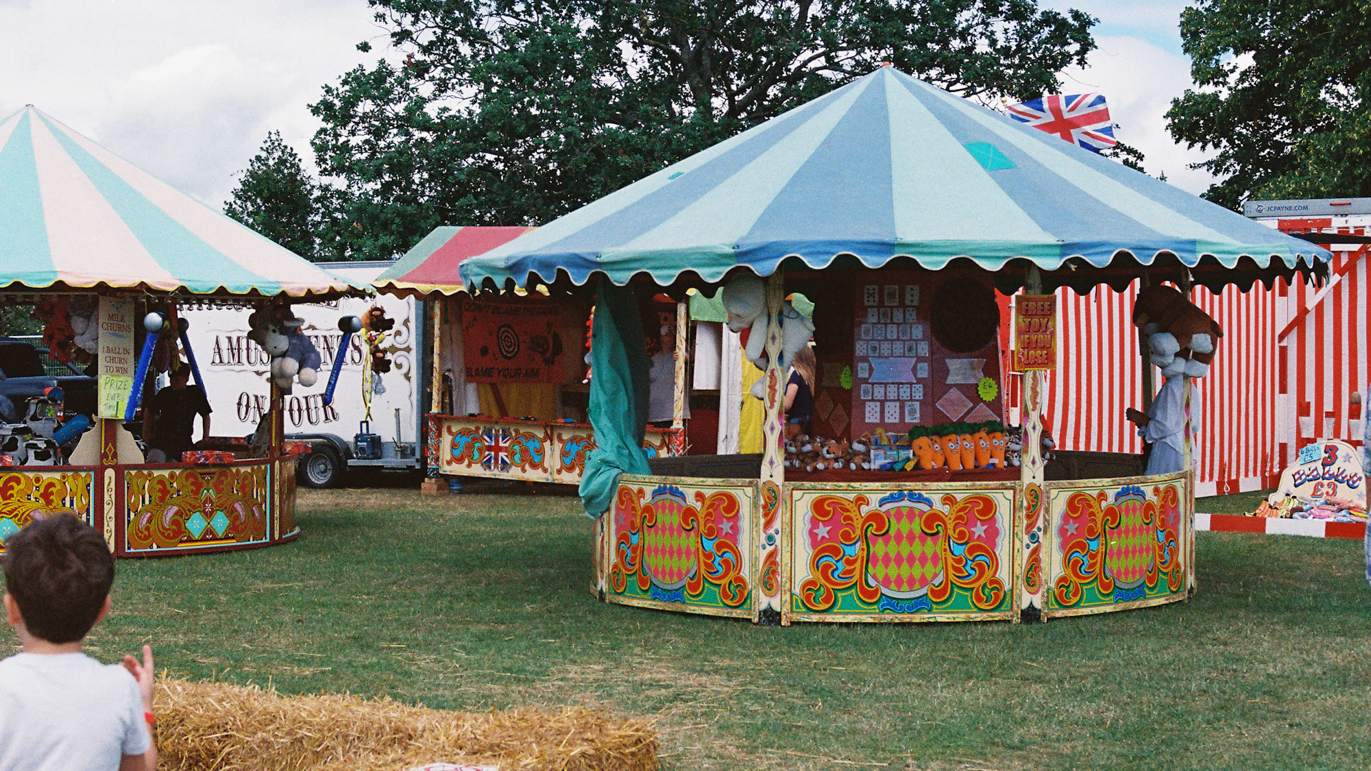 Striped fairground stalls and a Union Jack at an English village fete